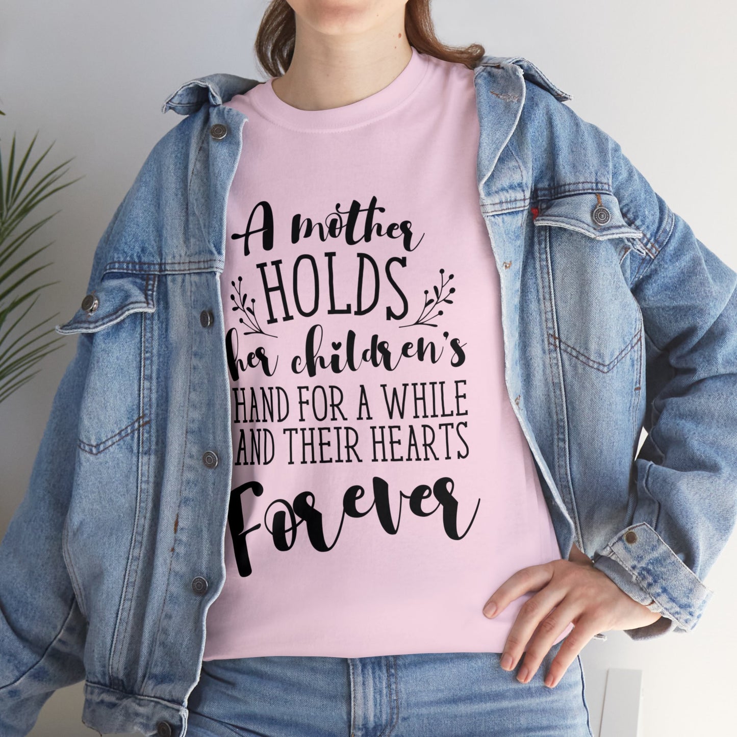 A mother holds her child's heart- Unisex Heavy Cotton Tee