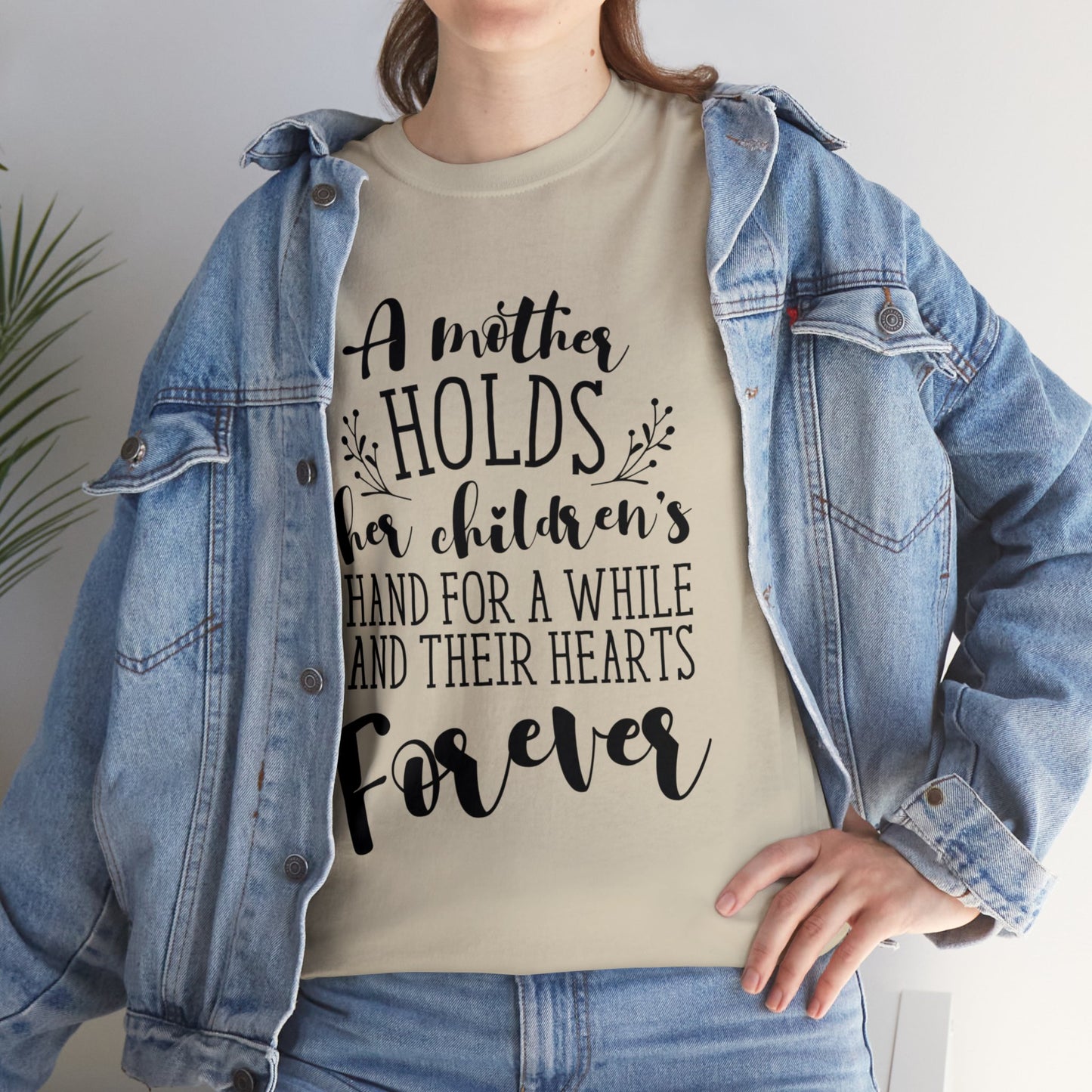 A mother holds her child's heart- Unisex Heavy Cotton Tee