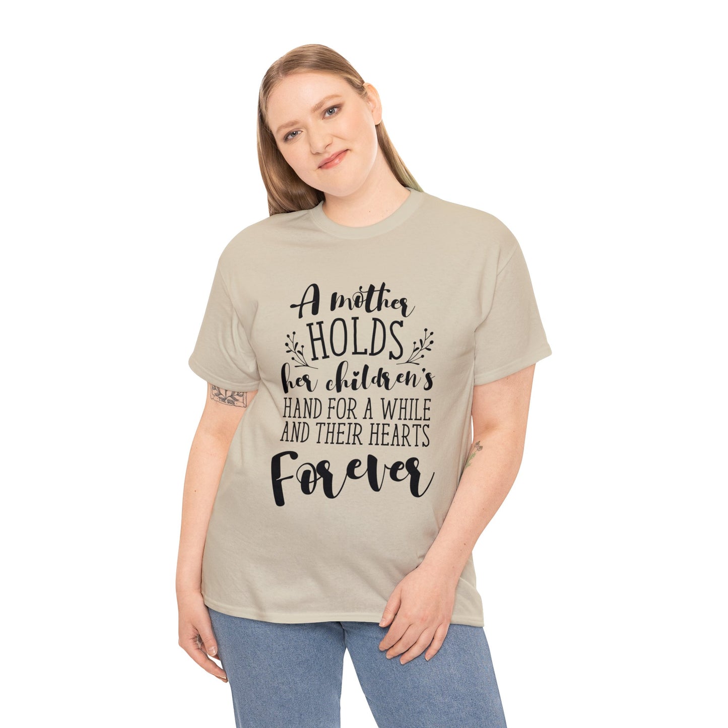 A mother holds her child's heart- Unisex Heavy Cotton Tee