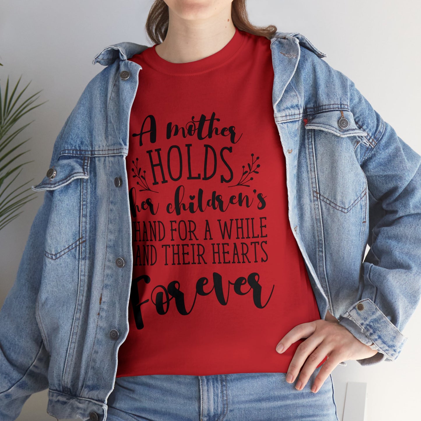 A mother holds her child's heart- Unisex Heavy Cotton Tee